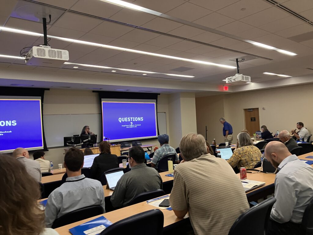 Picture of two people asking questions after a presentation