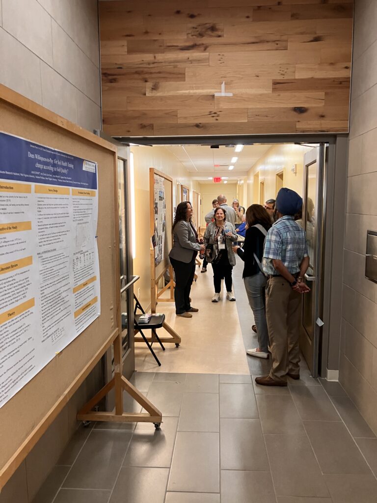 Picture of people looking at posters in hallway