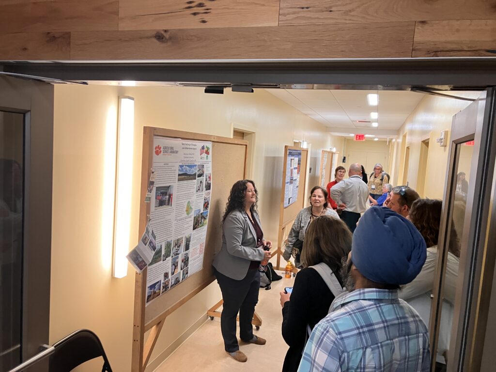 Picture of people looking at posters in hallway