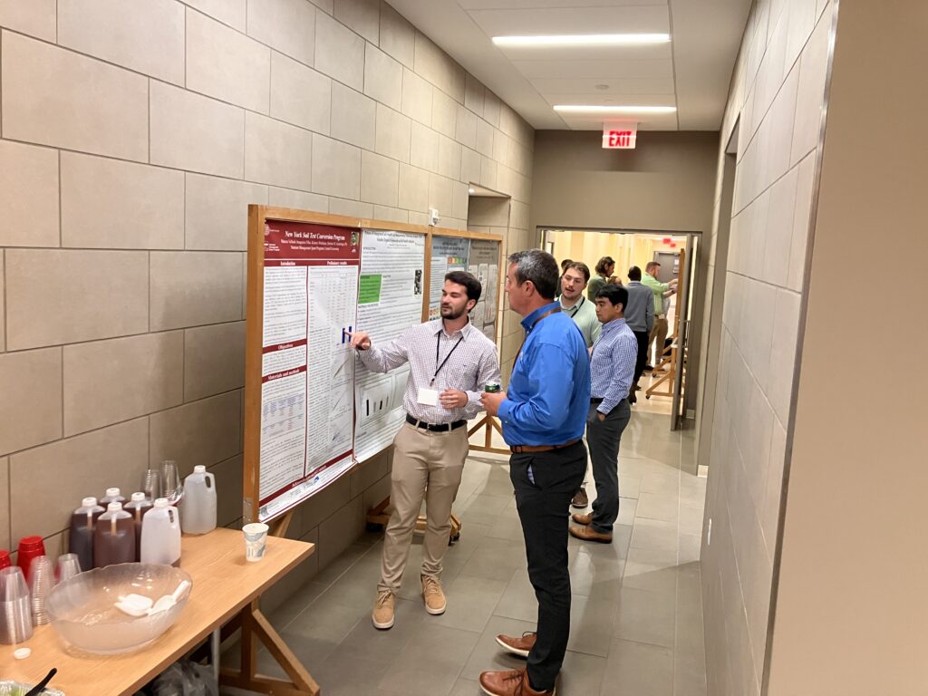 Picture of people looking at posters in hallway