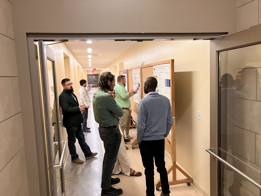 Picture of people looking at posters in hallway