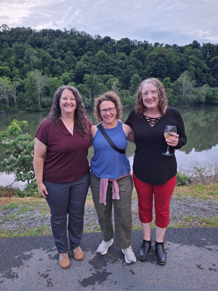 Three ladies in front of river